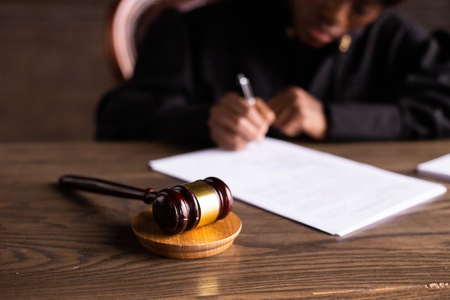 judge signing paper in court